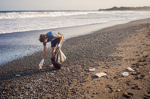Young-man-cleaning-up-the-beach.jpeg