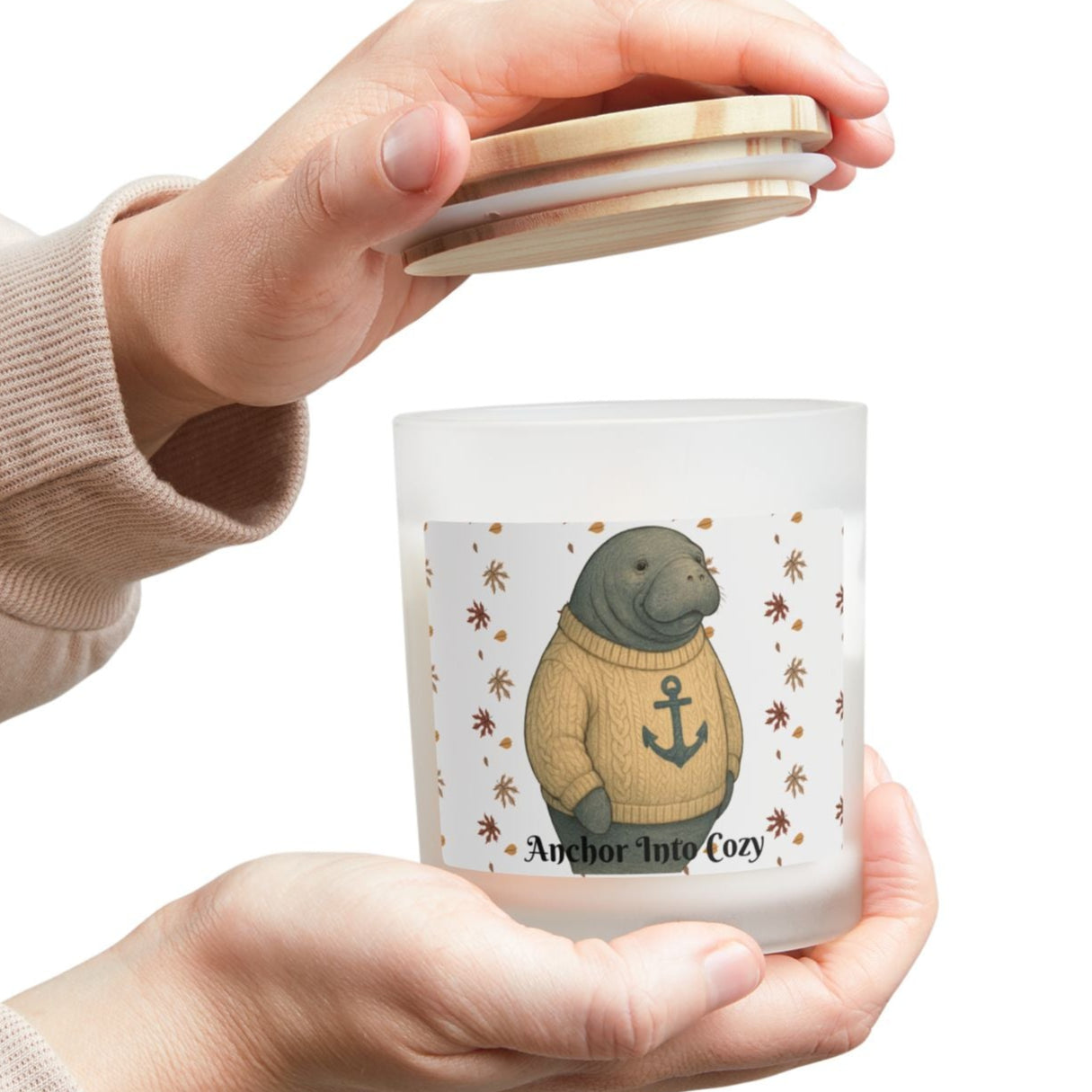 Person holding a small candle with a bear design on a white background