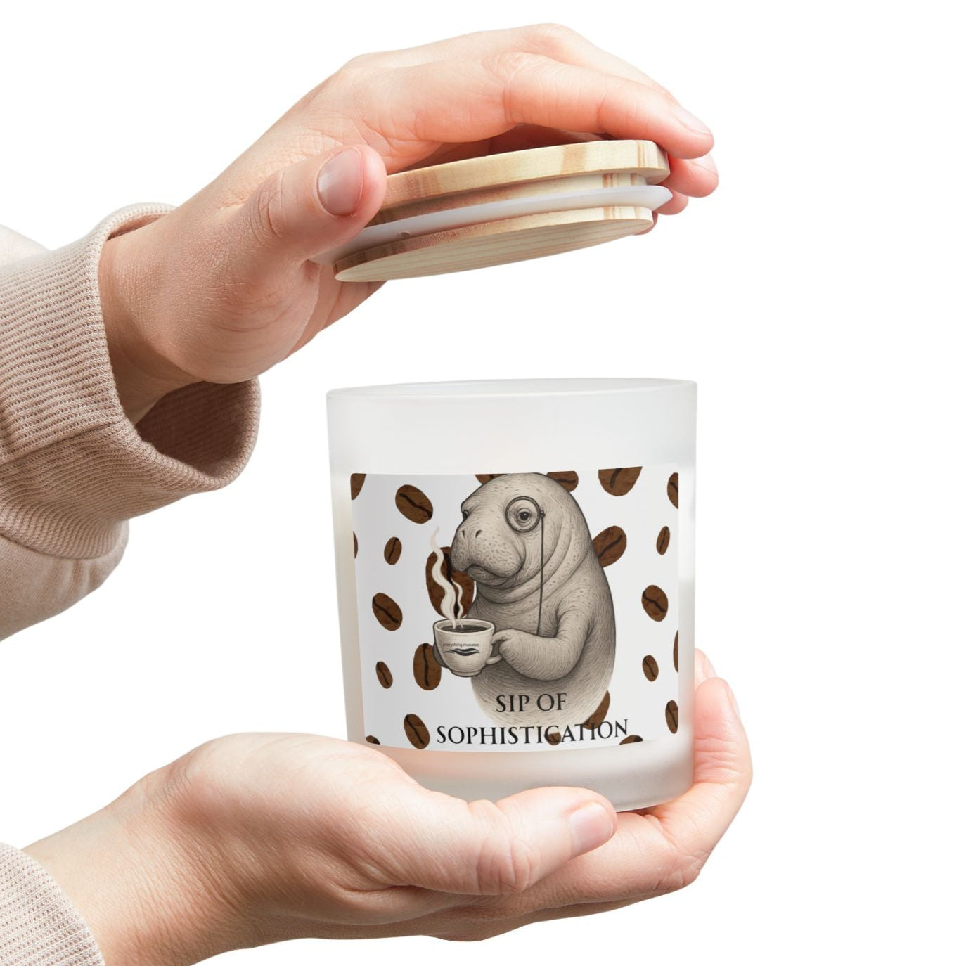 Person holding a white mug with a design and text, wearing a beige sweater.