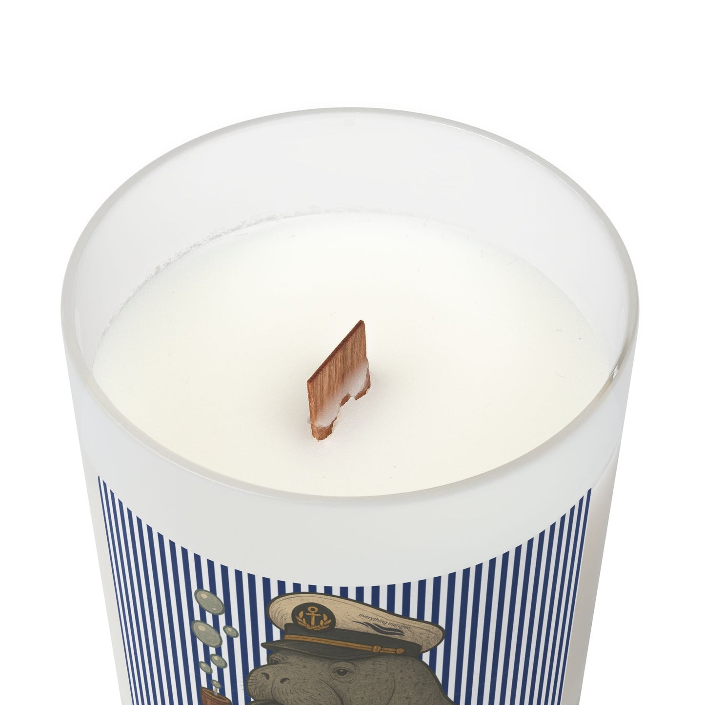 Candle in a container with a decorative label featuring a bear in a sailor hat on a white background