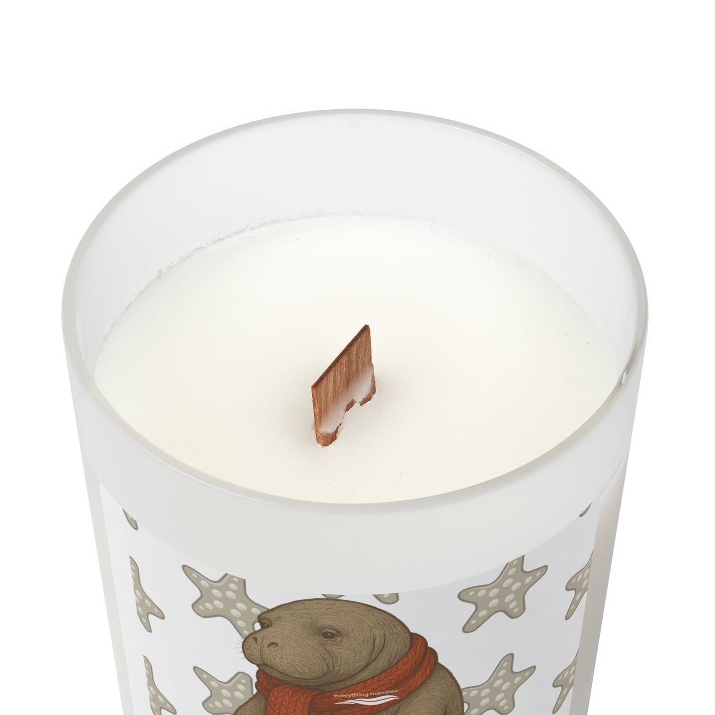 Candle with a design of a bear wearing a scarf on a white background