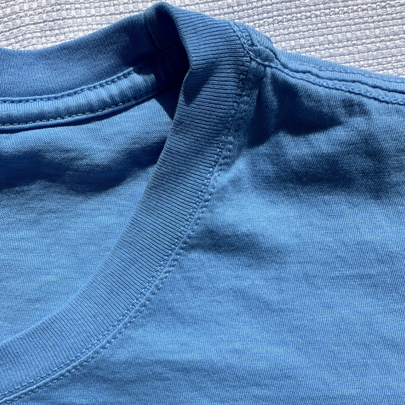 Close-up of Ocean Blue Manatee Wave Pocket T-Shirt neck and shoulder seams