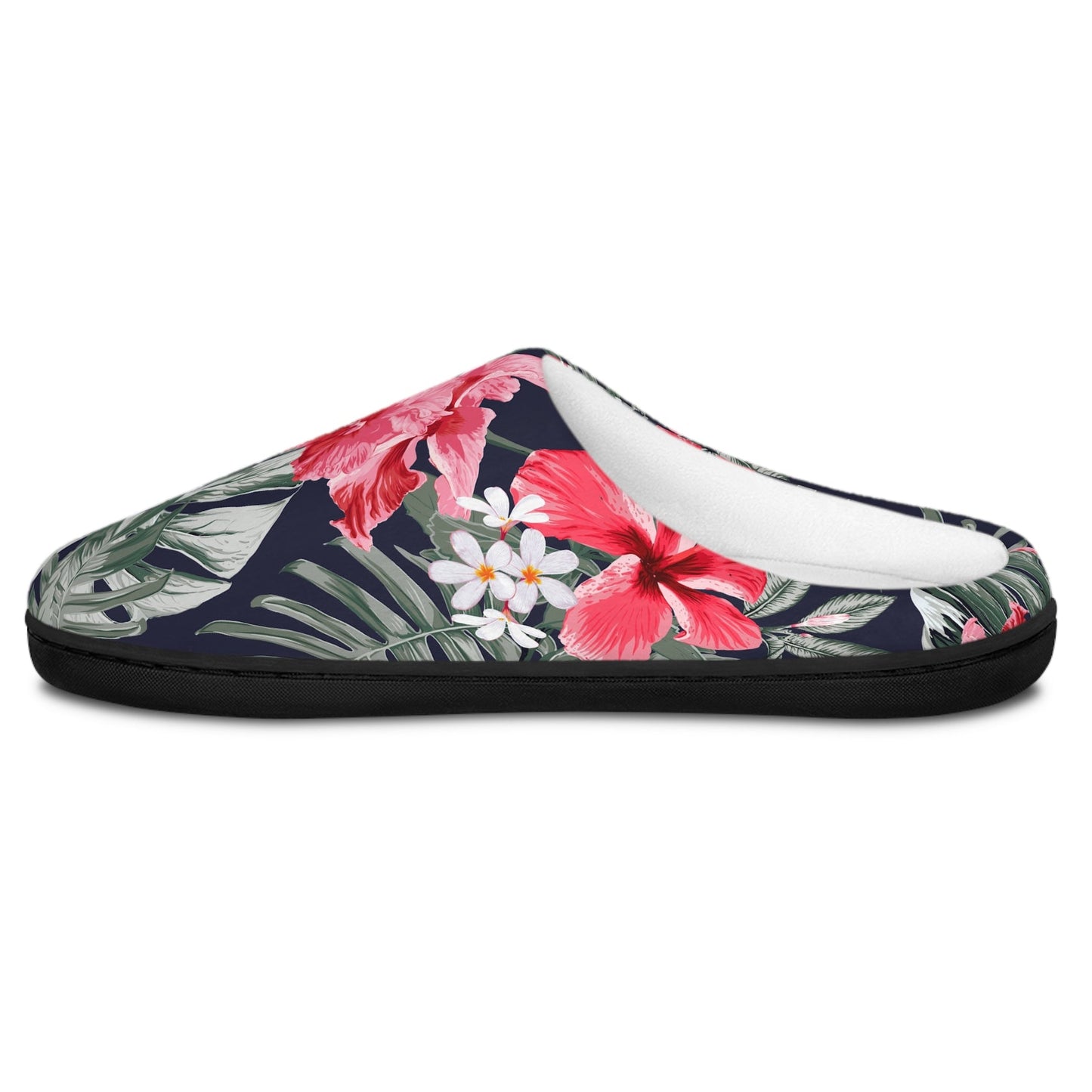 A single slip-on mule slipper with a tropical floral print on a dark navy background, featuring pink hibiscus flowers, green leaves, and white plumeria blossoms, shown against a plain white background.