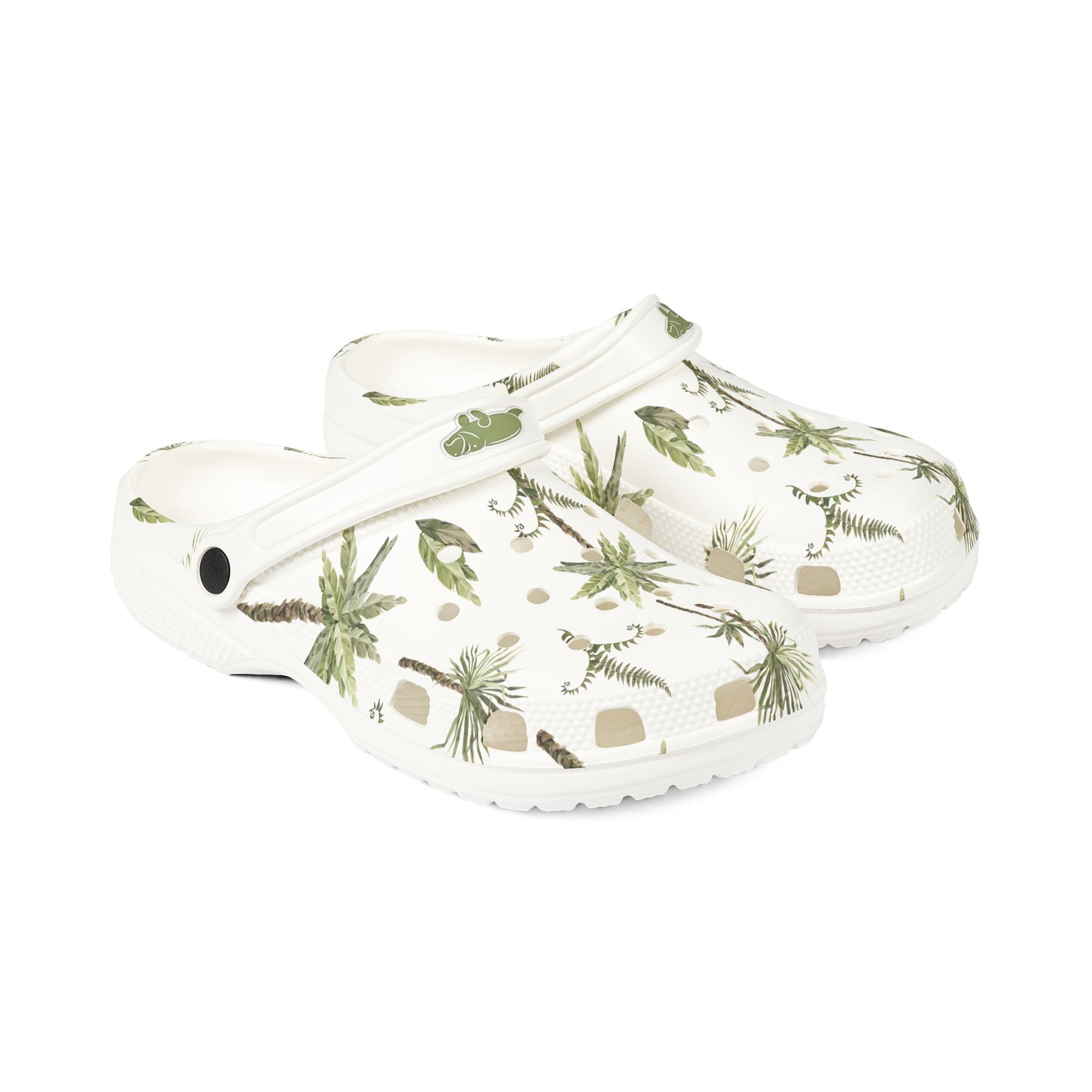 White clogs with green floral pattern on a white background