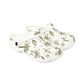 White clogs with green floral pattern on a white background