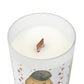 Candle with a design of a beaver wearing a sweater on a white background