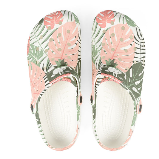 Tropical leaf patterned slippers on a white background