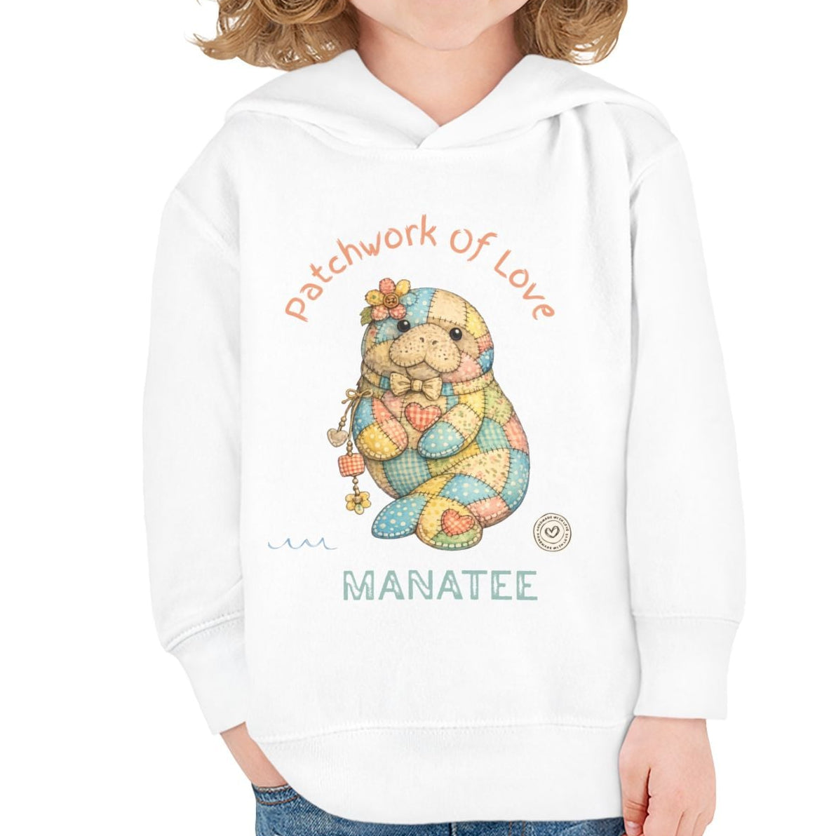 Child wearing a white hoodie with a cartoon manatee design and text on a white background