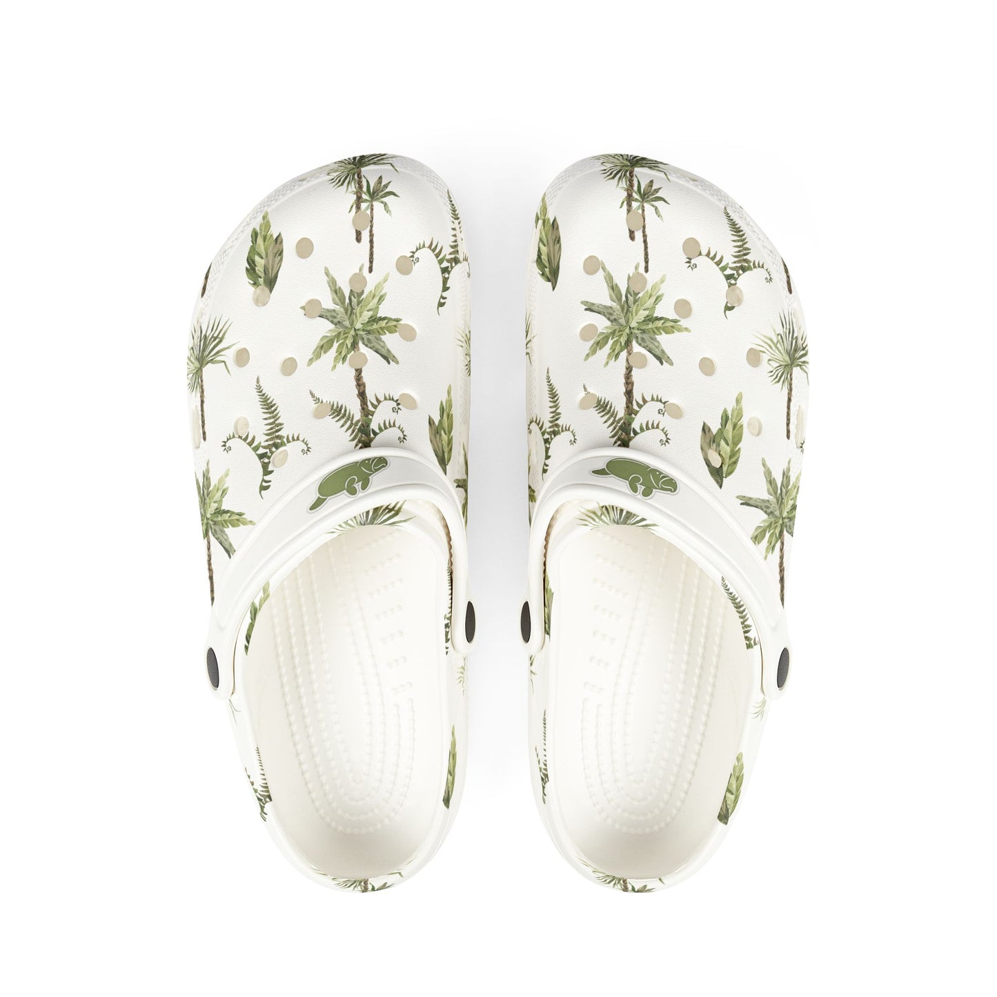 White clogs with tropical plant pattern on a white background