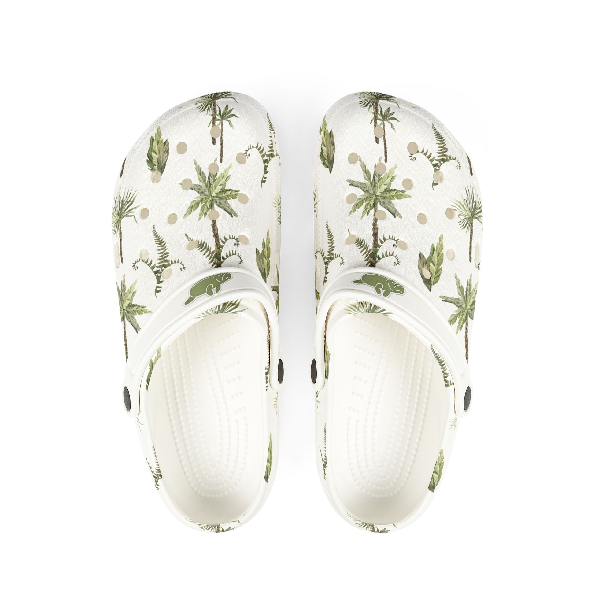 White clogs with tropical plant pattern on a white background