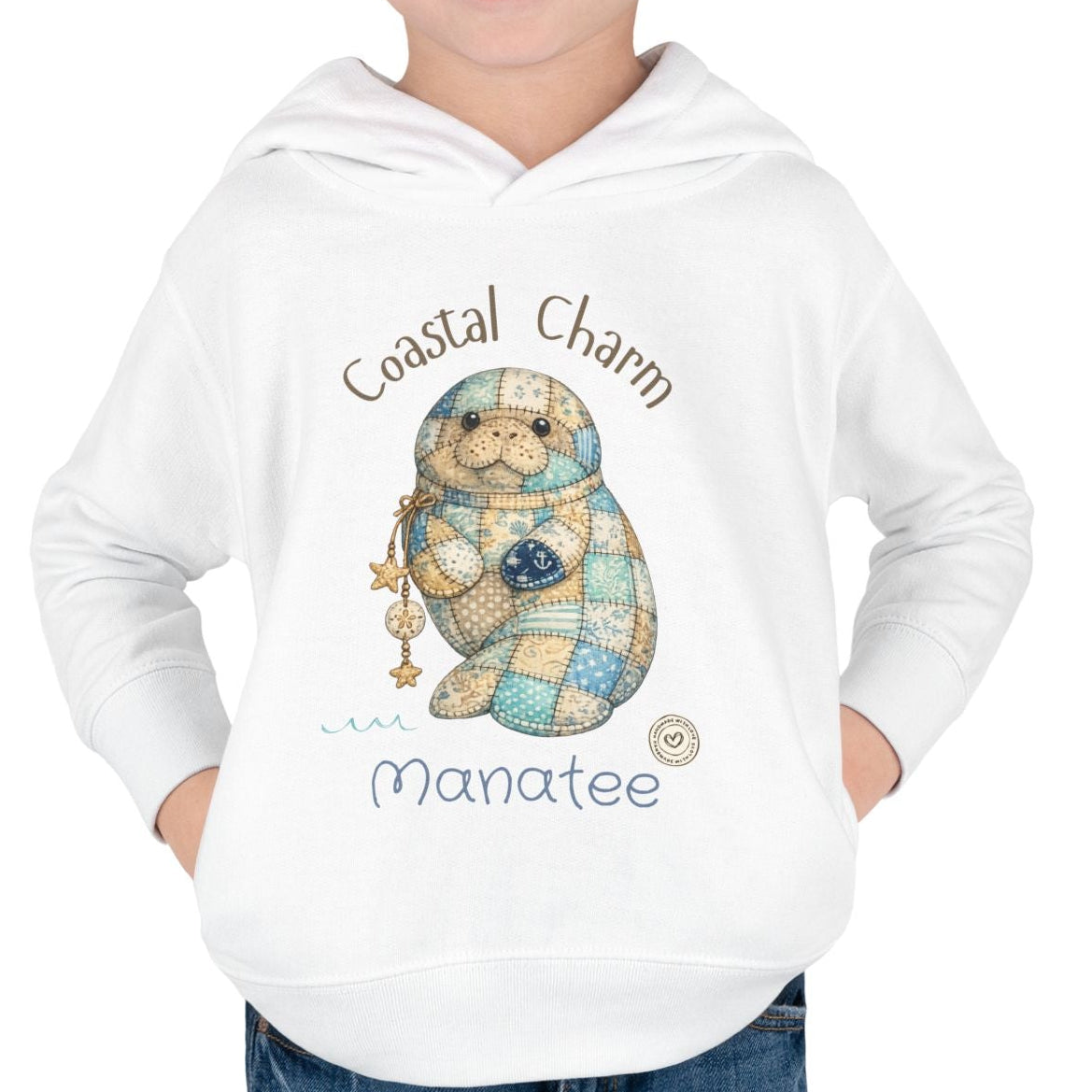 Child wearing a white hoodie with a cartoon manatee design and text on a white background