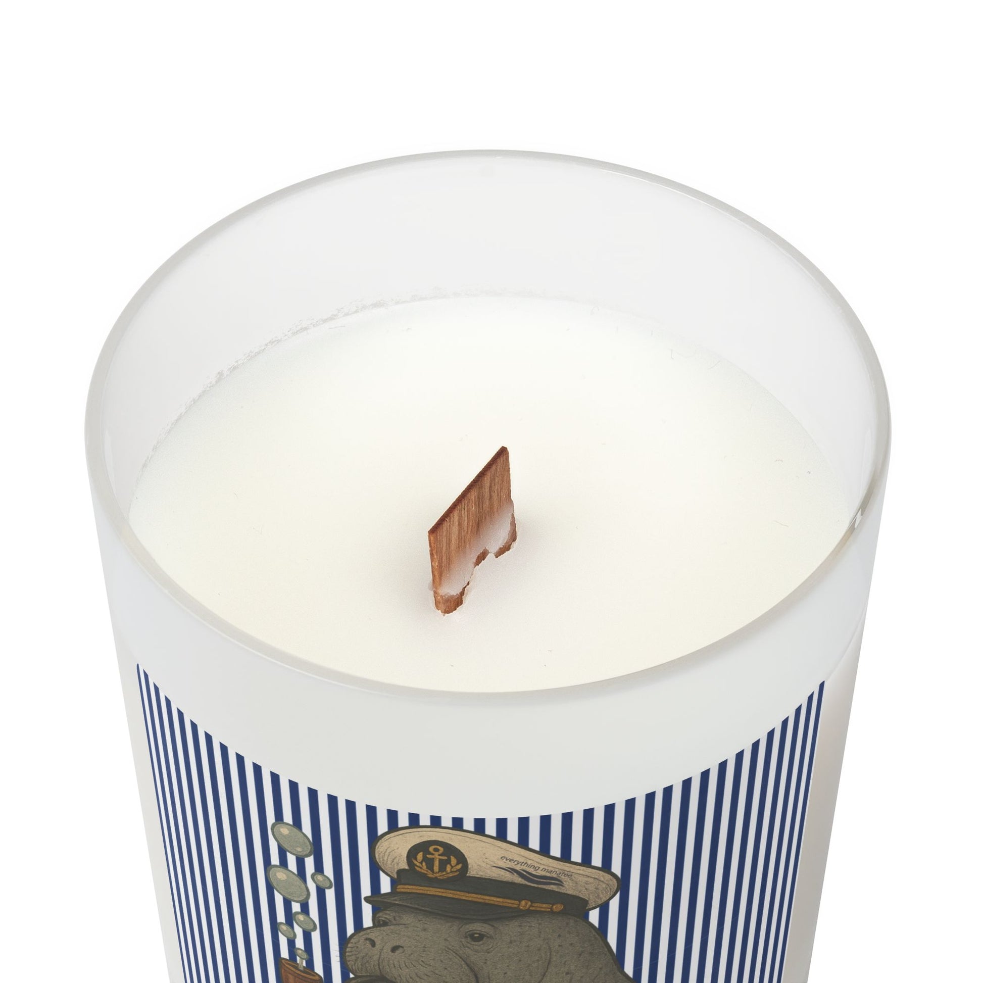 Candle in a container with a decorative label featuring a bear in a sailor hat on a white background