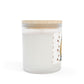White candle with a wooden lid and decorative label on a white background