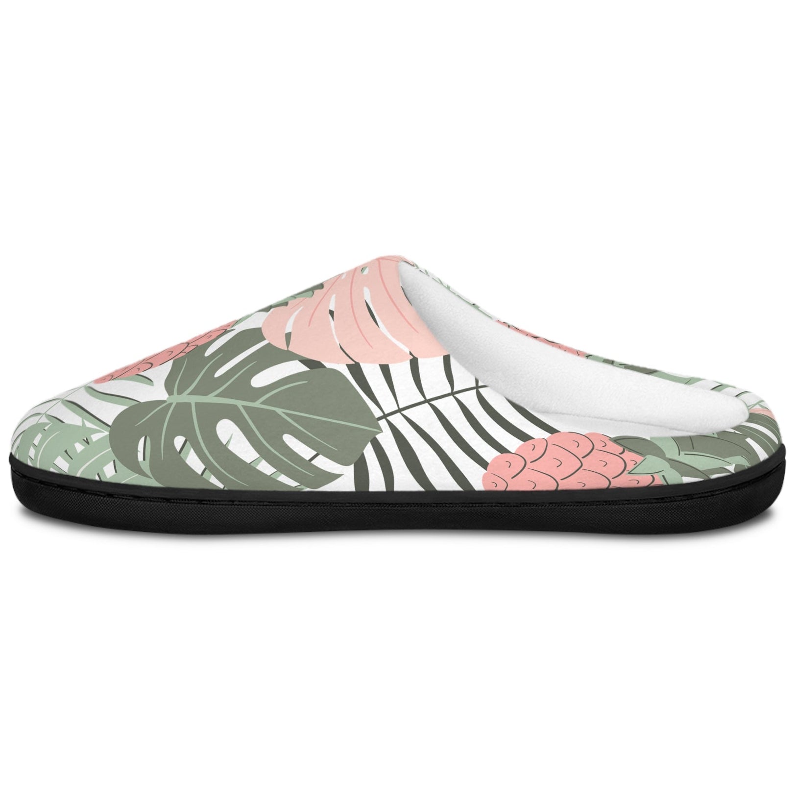 A single slip-on mule shoe with a tropical leaf pattern in green, pink, and black on a white background, shown from a side profile view.