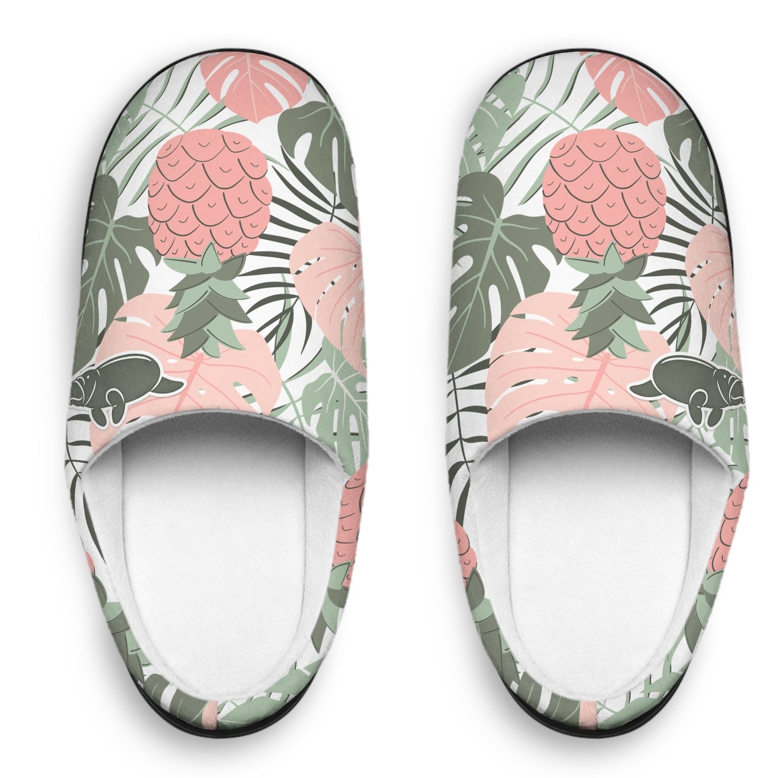 A pair of slip-on slippers with a tropical print featuring pink pineapples, green palm leaves, and black-and-white striped banana leaves on a white background.
