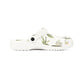 White clog shoe with green leaf pattern on a white background