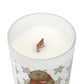 Candle with a design of a bear wearing a scarf on a white background