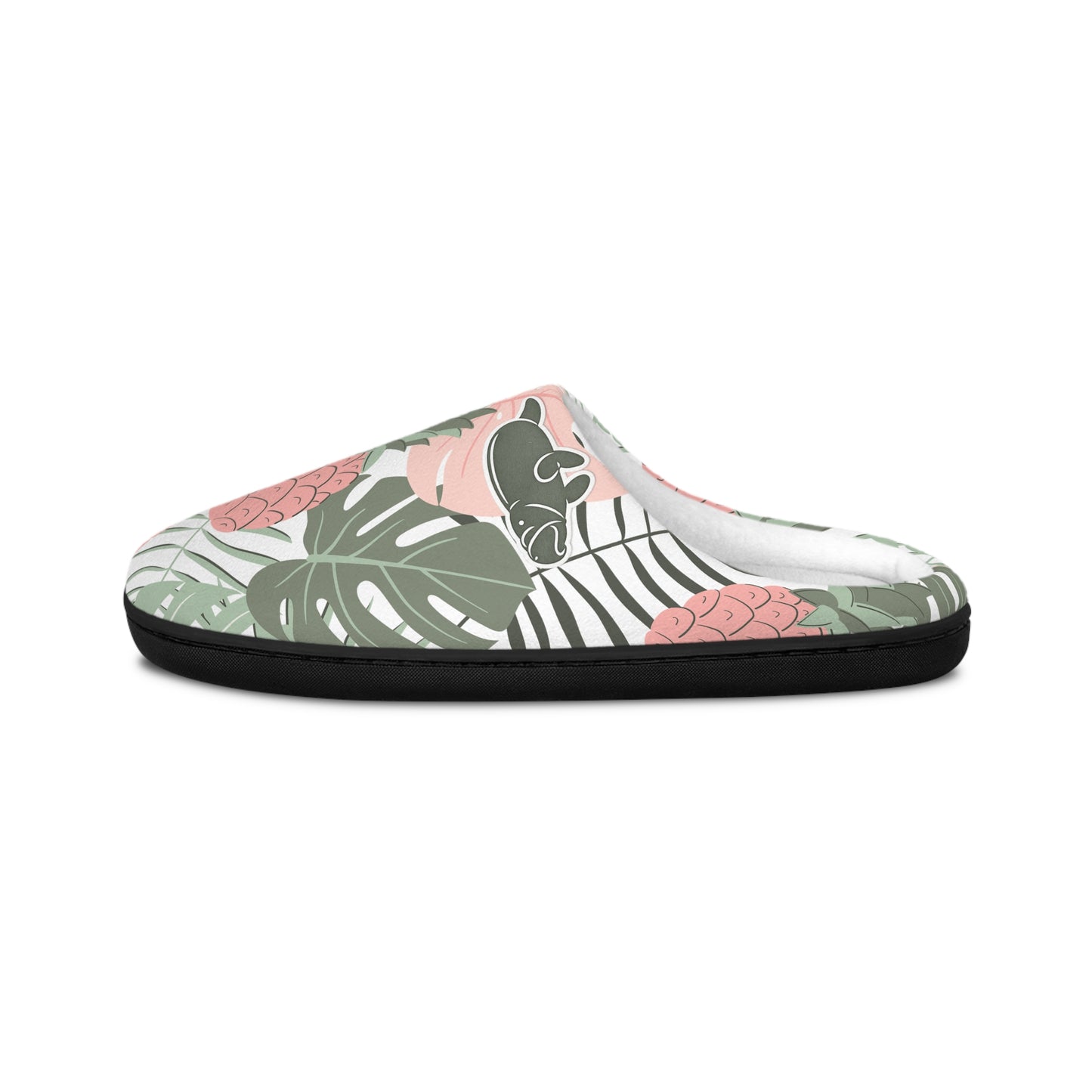 A single slip-on mule slipper with a tropical leaf and floral pattern in green, pink, black, and white, featuring a solid black outsole, shown against a plain white background.
