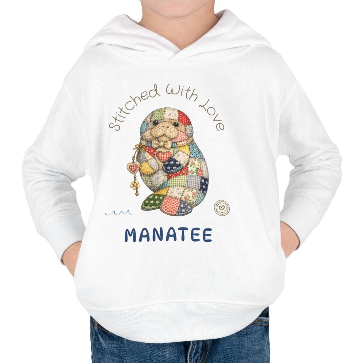 Child wearing a white hoodie with a cartoon manatee design and text on a white background