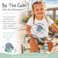 A young girl with braided hair rides a tricycle on a wooden boardwalk while wearing a white graphic T-shirt that reads 'Be The Calm Like the Manatees' with a cartoon manatee and starfish design. The image includes matching graphic elements and text on the left side.