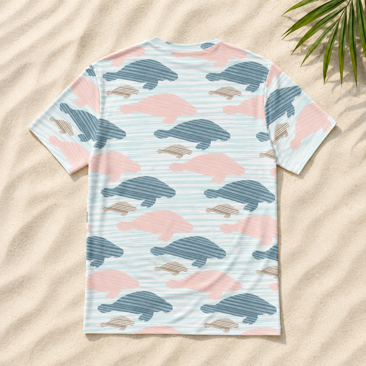 T-shirt with animal pattern on sand with palm leaf