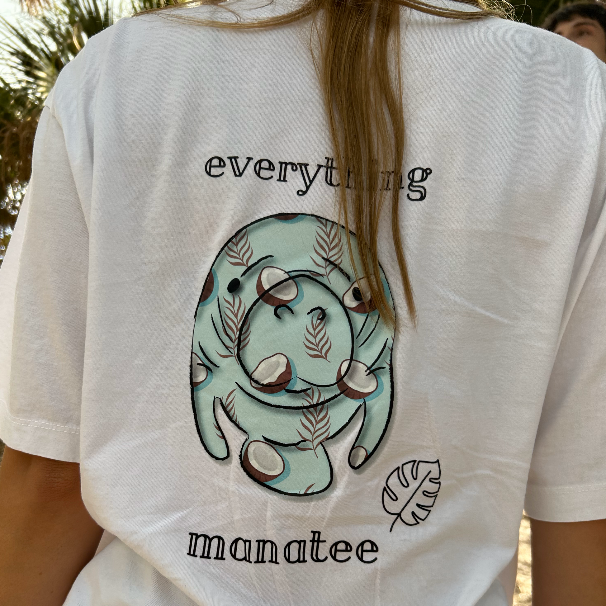 Close-up of back print on Coconuts & Palms Manatee T-Shirt in White Salt