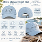 A size chart and fit guide for the Men's Manatee Drift Hat by Everything Manatee. The graphic features front and back views of a light blue baseball cap with a line-drawn manatee logo, along with a measurement table detailing head circumference, crown height, and bill length.