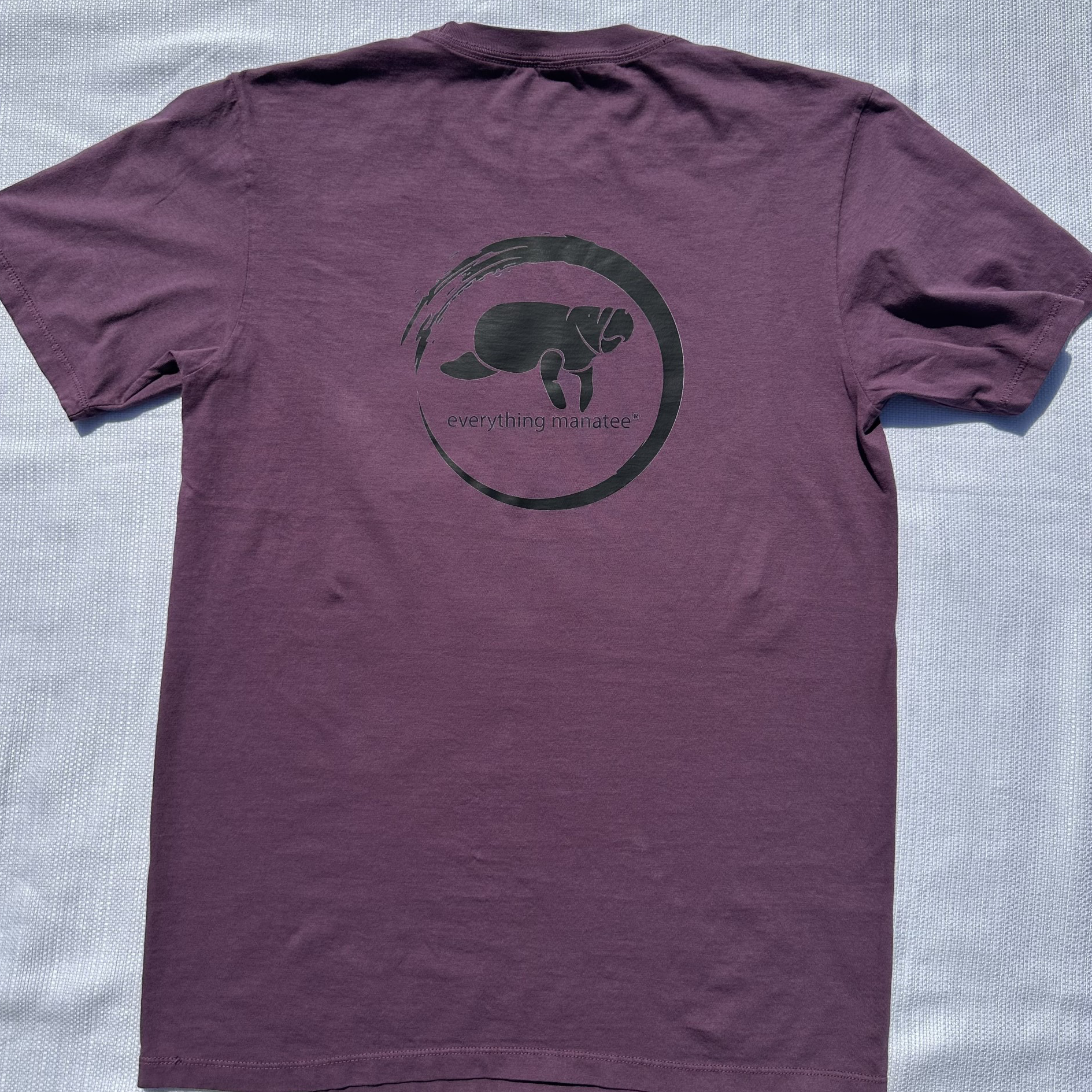 Back view of Midnight Grape Manatee Wave T-Shirt, showing relaxed fit and clean finished sleeve cuffs and hem.
