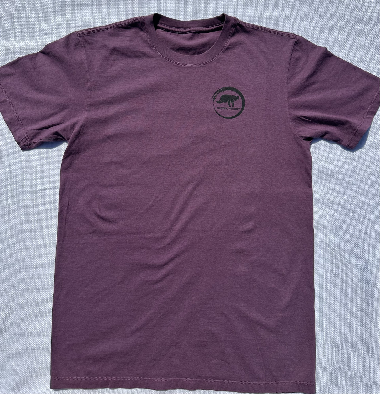 Front view of Midnight Grape Manatee Wave T-Shirt, featuring a playful manatee and unique wave design.