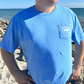 Lifestyle shot of front view of Ocean Blue Manatee Wave Pocket T-Shirt