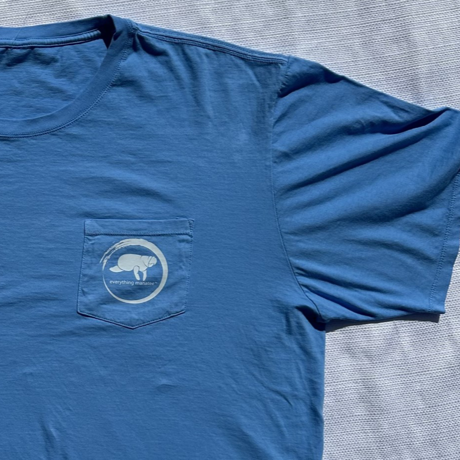 Flat lay view of Ocean Blue Manatee Wave Pocket T-Shirt shoulder and sleeve
