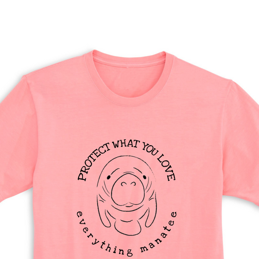 A close-up view of the front print design of the Pink Salt Protect Manatee T-Shirt, featuring a cute illustration of a manatee and the word "Protect" in bold letters above it.