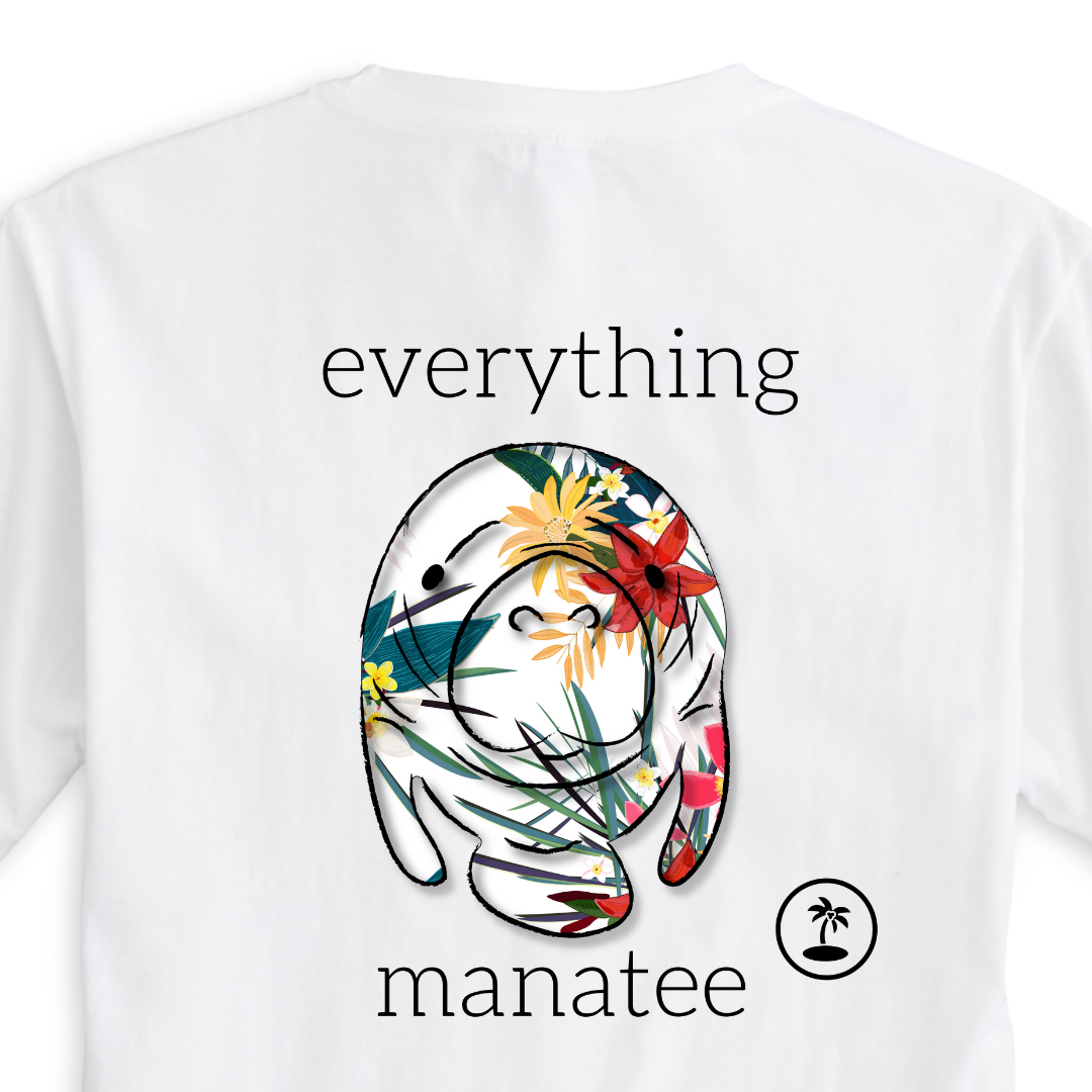 This image shows a close-up view of the fun manatee print with tropical flowers and bursting colors on the back of the Tropical Floral Manatee T-Shirt. The print is vibrant and detailed, adding personality to this comfortable t-shirt.
