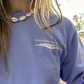 Zoomed-in front view of Unwind Manatee T-Shirt in Laid Back Lavender